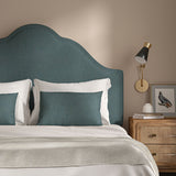 Blue headboard upholstered in a versatile woven fabric.