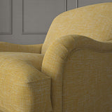 Yellow chair upholstered in a versatile woven fabric.