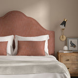 Red headboard upholstered in a versatile woven fabric.