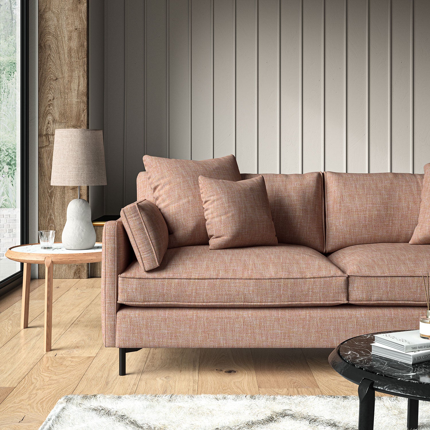 Pink sofa upholstered in a versatile woven fabric.