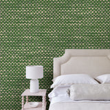 Bedroom featuring green wallpaper with faux basketweave pattern