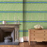 Sitting room with a playful green and blue wallpaper with a combination of tonal stripes, zigzags, and matching colour bands.