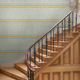 Hall with a blue and yellow wallpaper with a combination of tonal stripes, zigzags, and matching colour bands.