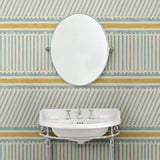 Cloakoom with a blue and yellow wallpaper with a combination of tonal stripes, zigzags, and matching colour bands.