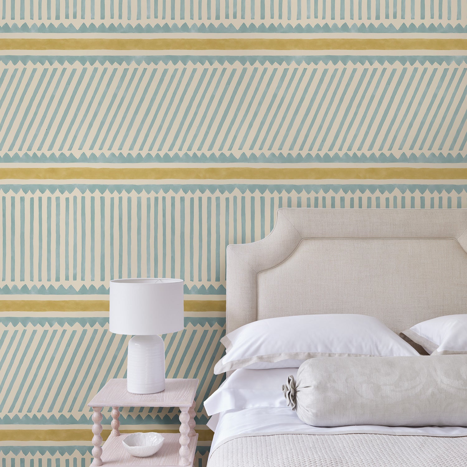 Bedroom with a blue and yellow wallpaper with a combination of tonal stripes, zigzags, and matching colour bands.