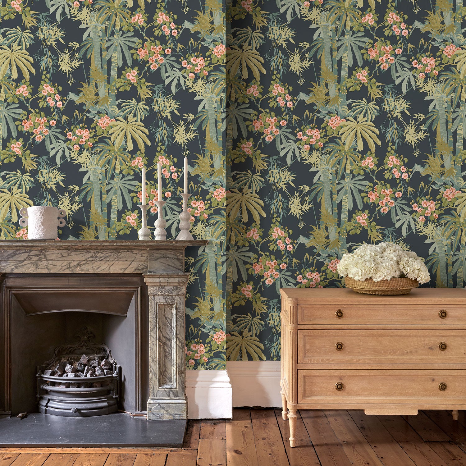 Sitting with a tropical wallpaper in navy with exotic, floral blossoms intertwined with bamboo.