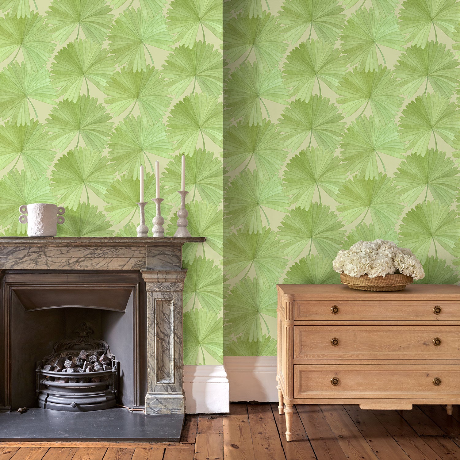 Living room showing a contemporary floral wallpaper with tropical palms in fresh greens.