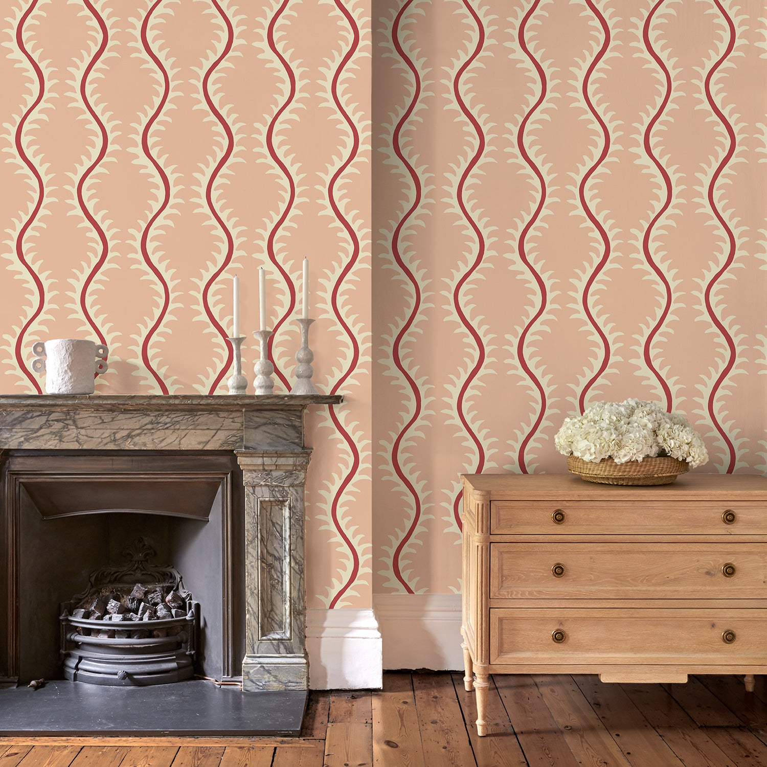 Luxurious wallpaper featuring stylised ferns and wavy lines in pink and red.