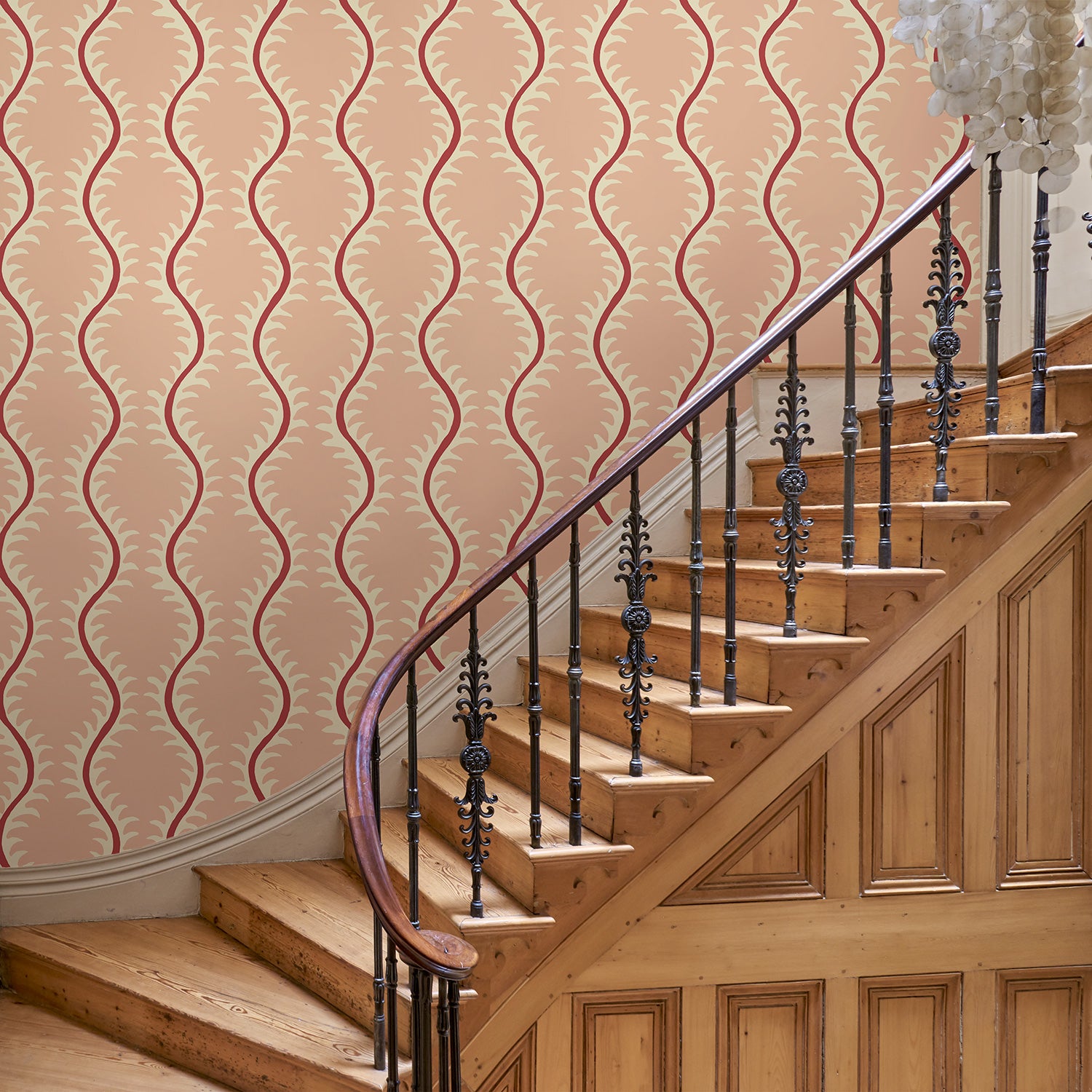 Luxurious wallpaper featuring stylised ferns and wavy lines in pink and red.