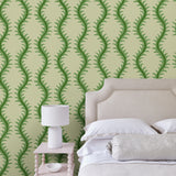 Luxurious wallpaper featuring stylised ferns and wavy lines in green and cream.