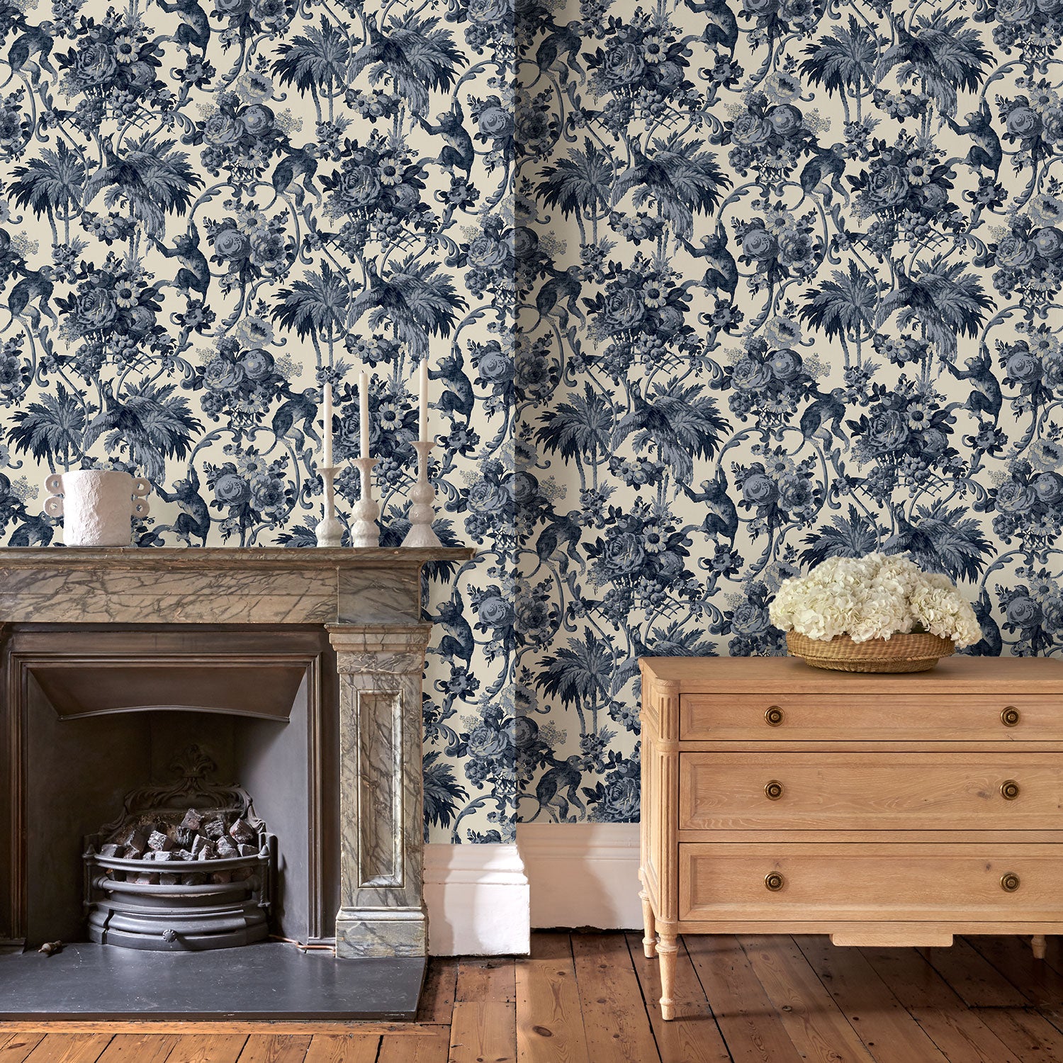 Sitting room with a tropical wallpaper with a classic monkey pattern.