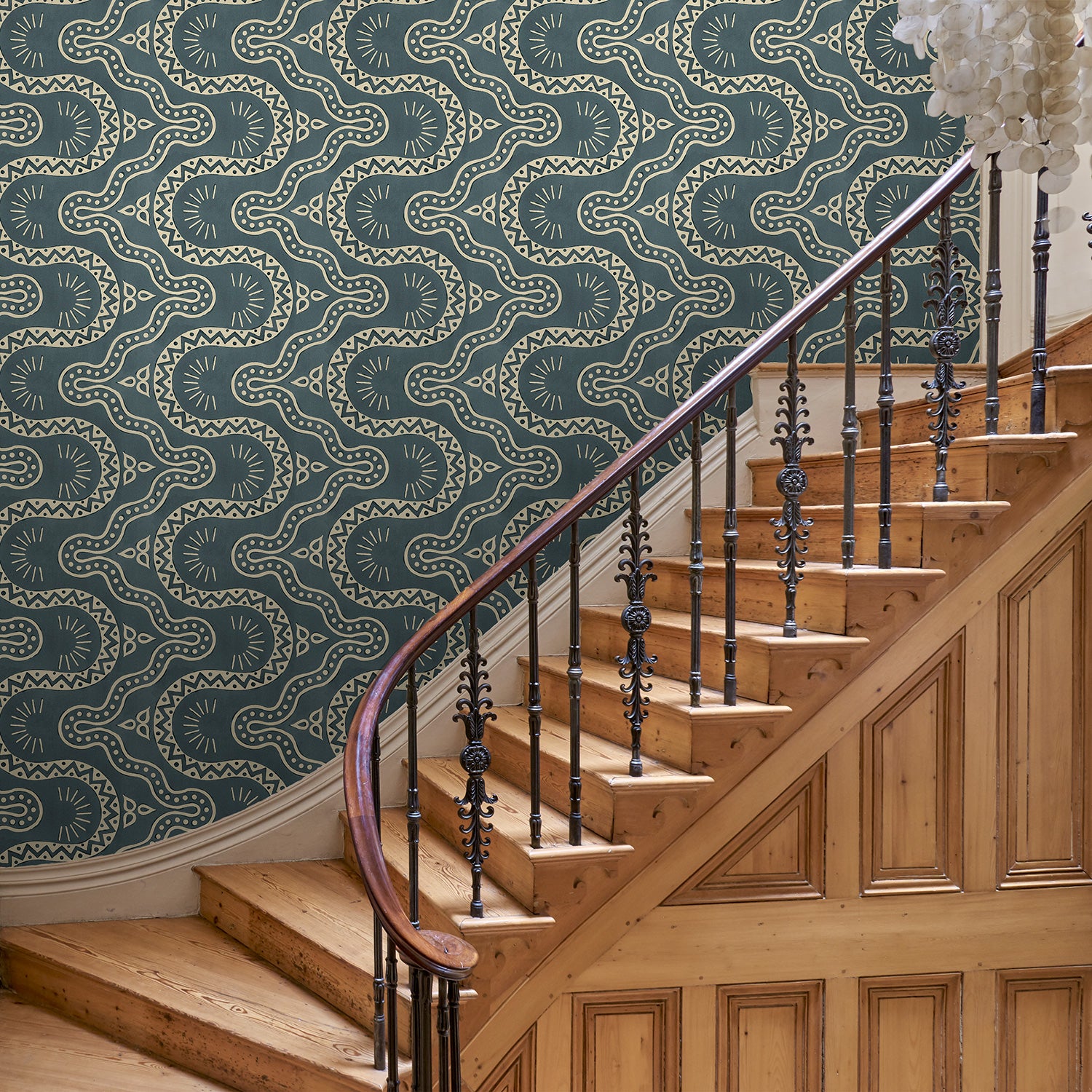 Hall with a blue geometric wallpaper.