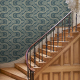 Hall with a blue geometric wallpaper.