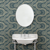Bathroom with a blue geometric wallpaper.