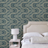 Bedroom with a blue geometric wallpaper.