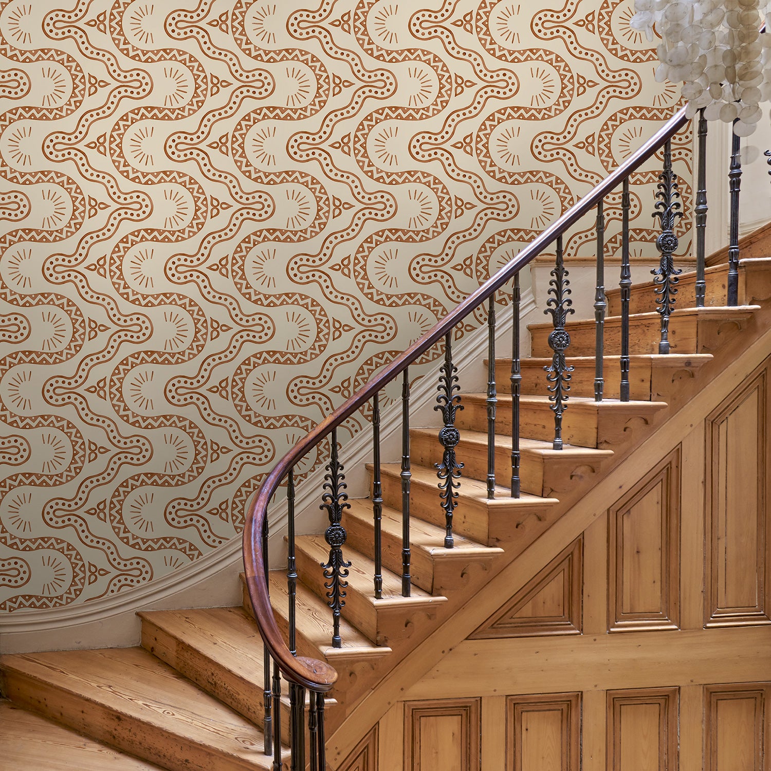 Hal with a brown geometric wallpaper.