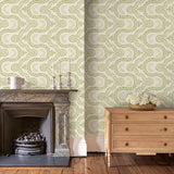 Sitting room with a green geometric wallpaper.