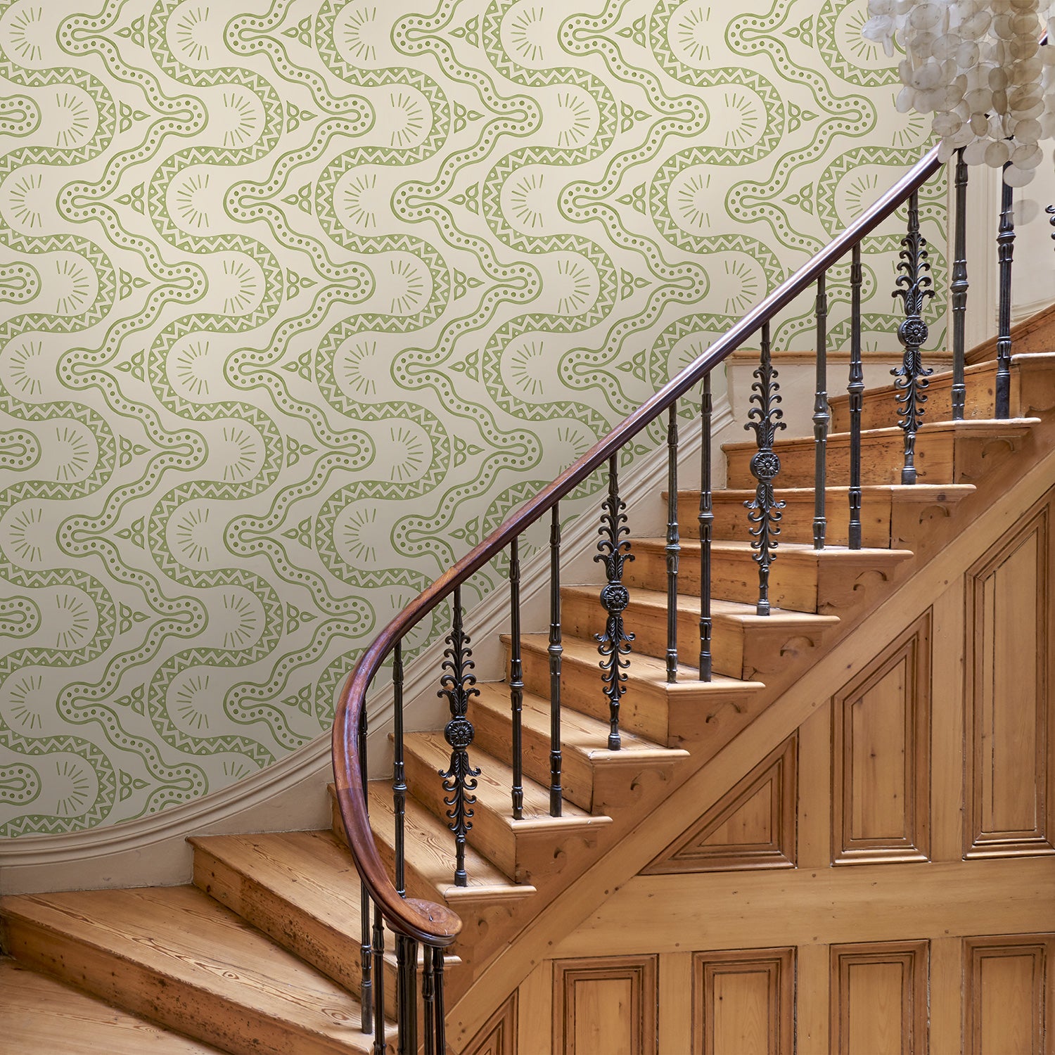 Hall with a green geometric wallpaper.