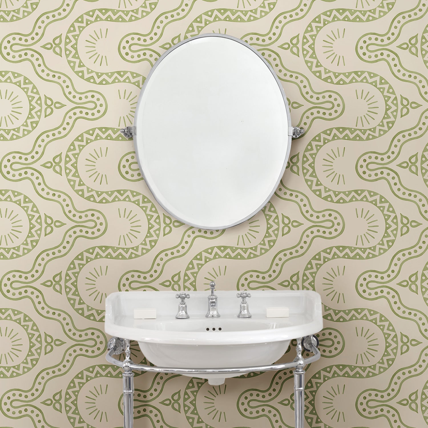 Cloakoom with a green geometric wallpaper.