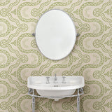 Cloakoom with a green geometric wallpaper.