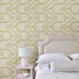 Bedroom with a green geometric wallpaper.