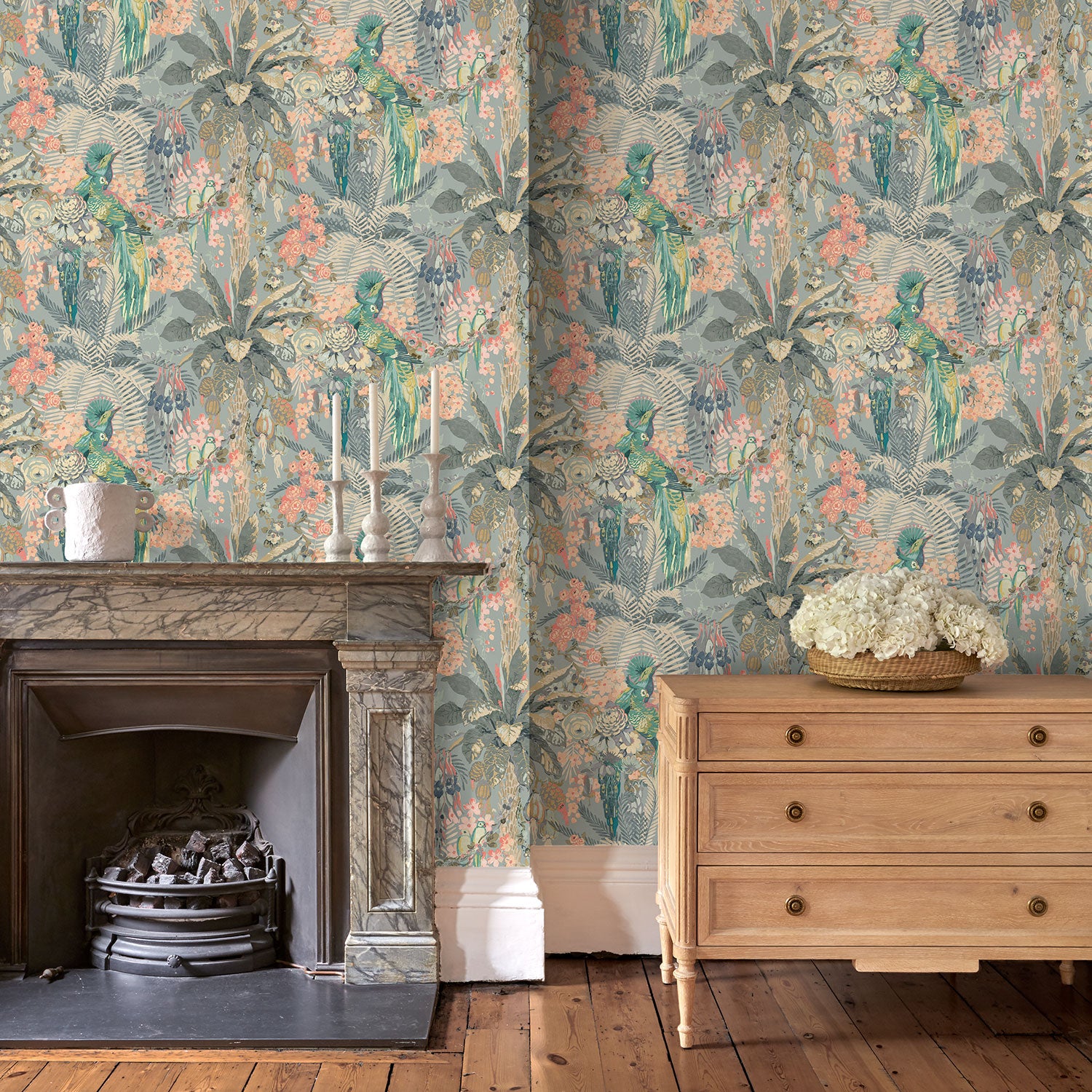 Tropical wallpaper in blue, shown in a sitting room.