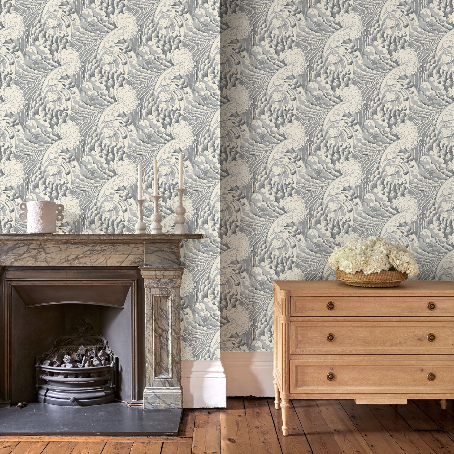 Sitting room with stylish abstract wallpaper featuring dramatic, undulating waves.