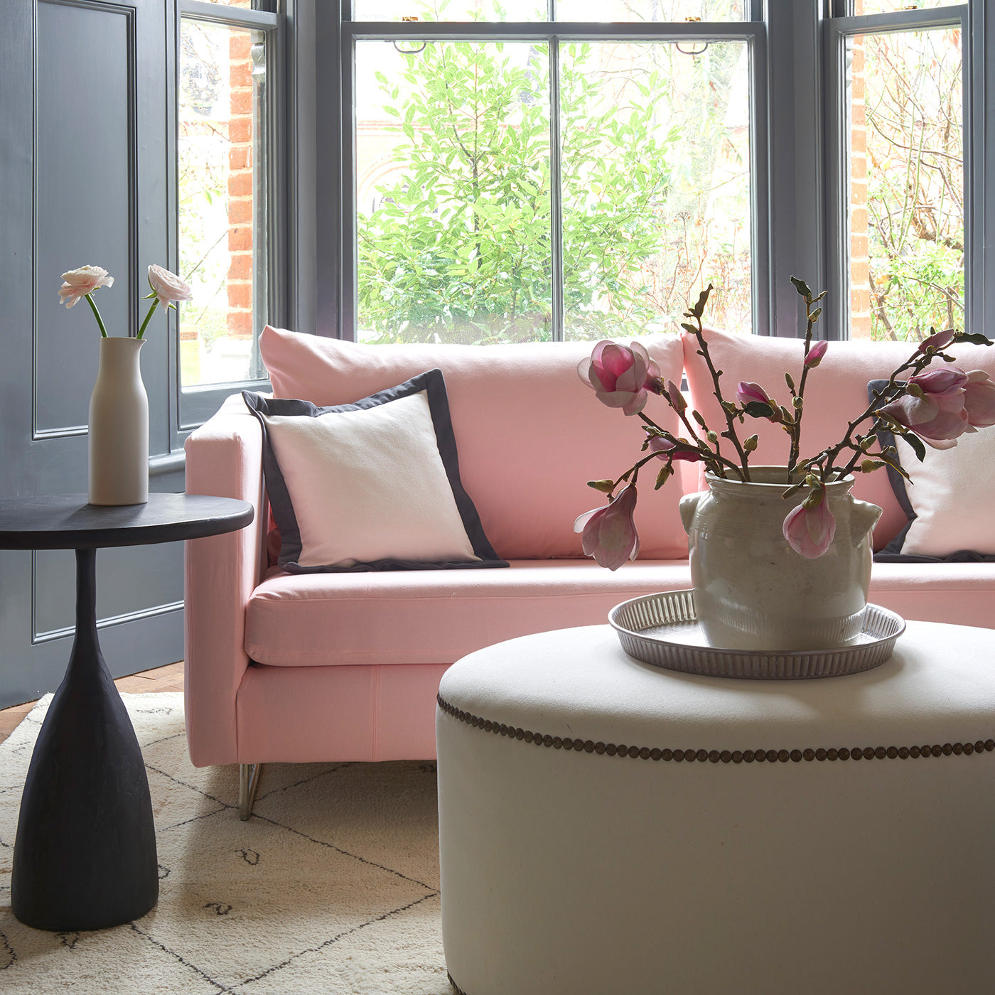 Living room featuring a sofa and curtains in a plain pastel pink eco-friendly fabric