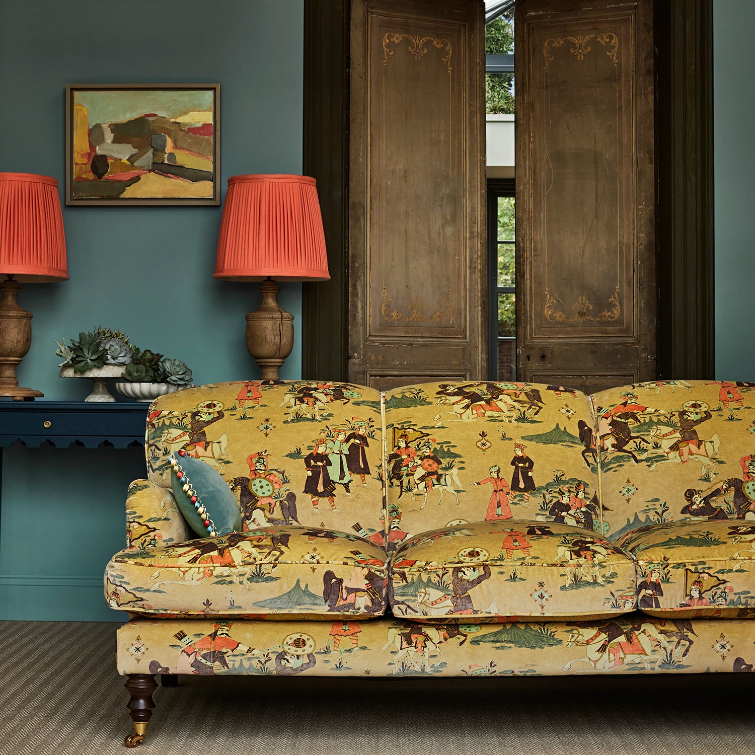 A printed velvet fabric showcasing lively horses and bedecked warriors in brown on a sofa