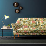 Sofa covered in a floral-style printed velvet fabric in olive.