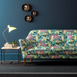 Sofa covered in a floral-style printed velvet fabric in pink, green and blue.