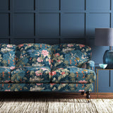 Sofa upholstered in a blue-coloured velvet upholstery fabric with a floral and bird design with a stain resistant finish.