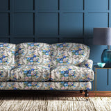 Sofa upholstered in a velvet upholstery fabric with stain resistant finish and vibrant colourful flower bouquet