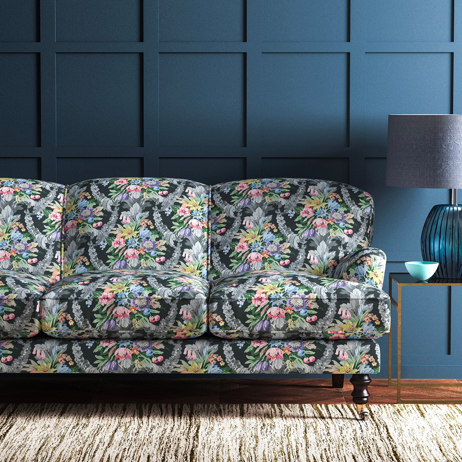 Sofa upholstered in a velvet upholstery fabric with stain resistant finish and vibrant colourful flower bouquet