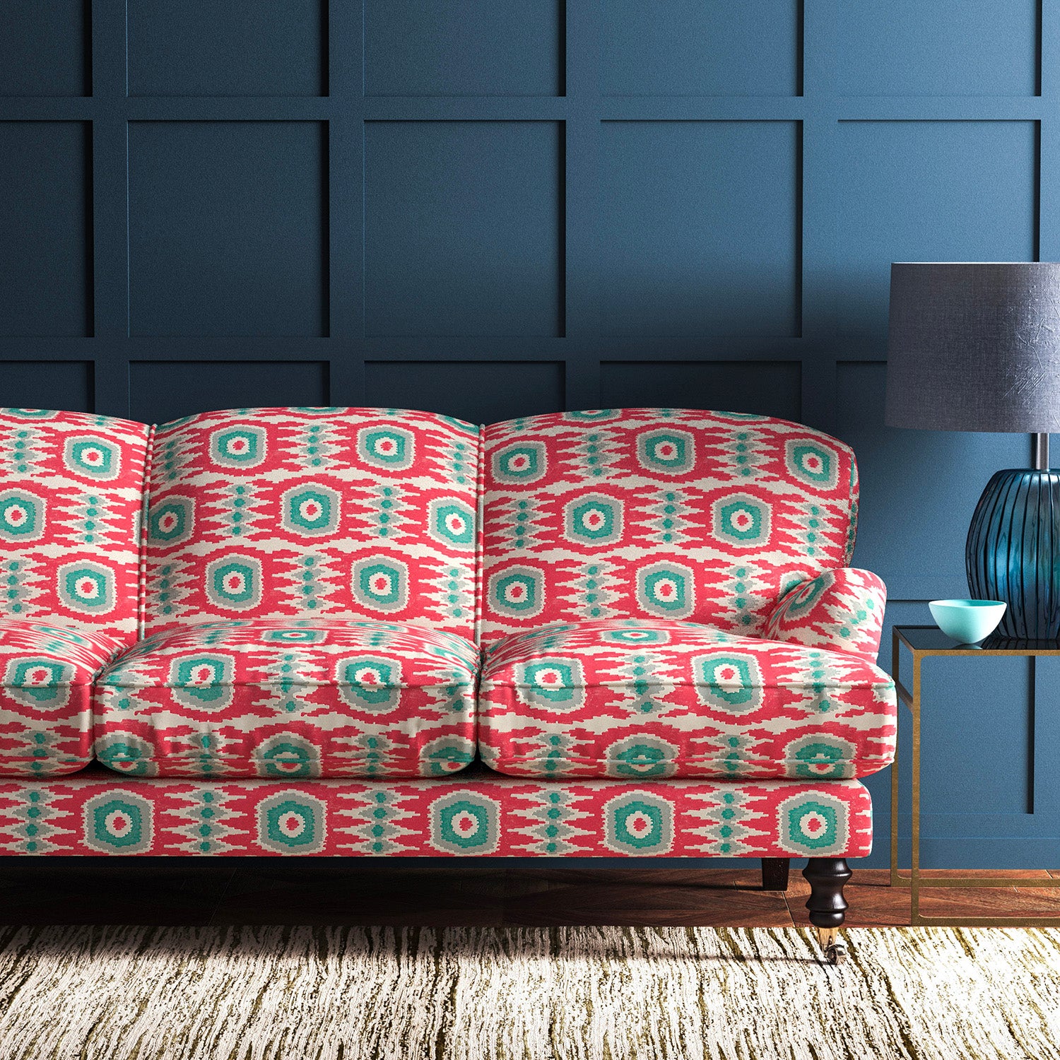 Sofa covered in a printed velvet upholstery fabric featuring a fun, jazzy pattern in Mandarin Orange. 