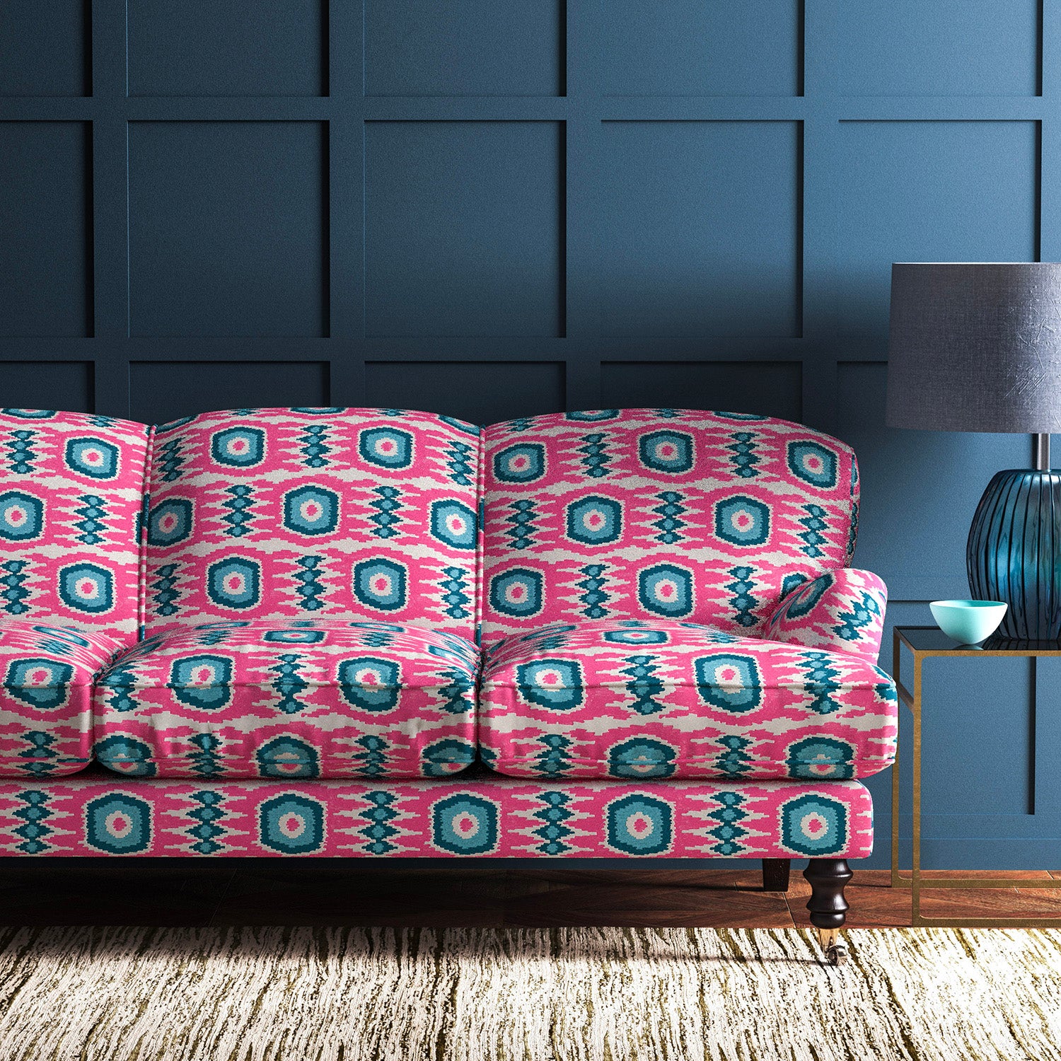 Sofa covered in a printed velvet upholstery fabric featuring a fun, jazzy pattern in Candy Pink. 