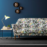 Sofa upholstered in a velvet upholstery fabric with stain resistant finish and vibrant colourful flower bouquet