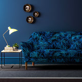 Sofa upholstered in an electric blue printed velvet upholstery fabric with palm leaf design. 