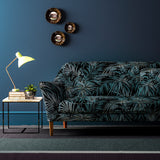 Sofa upholstered in a grey/blue printed velvet upholstery fabric with palm leaf design.