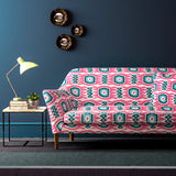 Sofa covered in a printed velvet upholstery fabric featuring a fun, jazzy pattern in Candy Pink. 