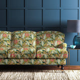 Sofa covered in a floral-style printed velvet fabric in olive.
