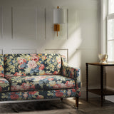 Sofa in a printed linen fabric with bouquets of roses in multicolours.