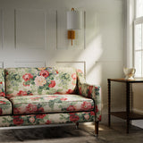 Sofa in a printed linen fabric with bouquets of red roses.