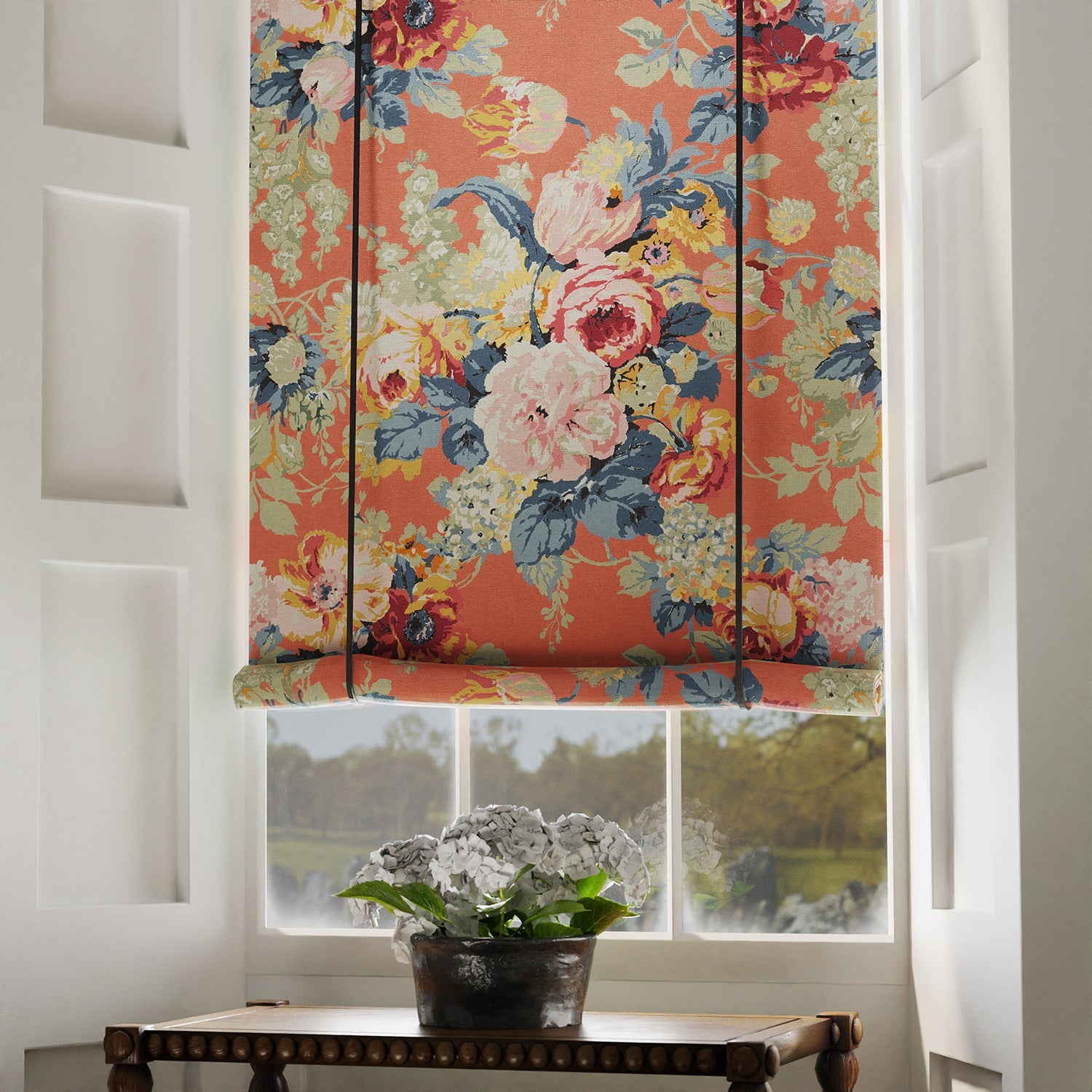 Blind in a printed linen fabric with bouquets of roses on an orange backdrop.