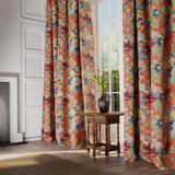 Curtains in a printed linen fabric with bouquets of roses on an orange backdrop.