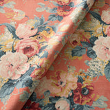 Printed linen fabric with bouquets of roses on an orange backdrop.