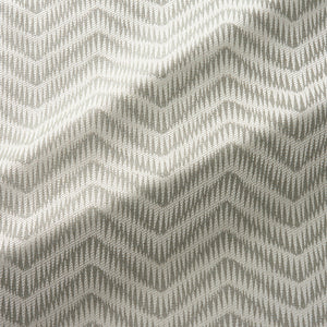 Fabric swatch of a herringbone weave design in neutral colours, suitable for curtains and upholstery