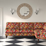 Velvet sofa upholstered in a printed velvet fabric with a intricate mirror dragon design in red colours.