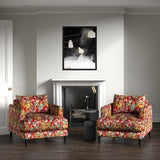 Velvet armchairs upholstered in a printed velvet fabric with a intricate mirror dragon design in red colours.