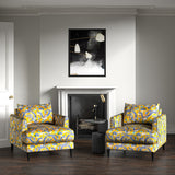 Velvet armchairs upholstered in a printed velvet fabric with a intricate mirror dragon design in yellow colours.